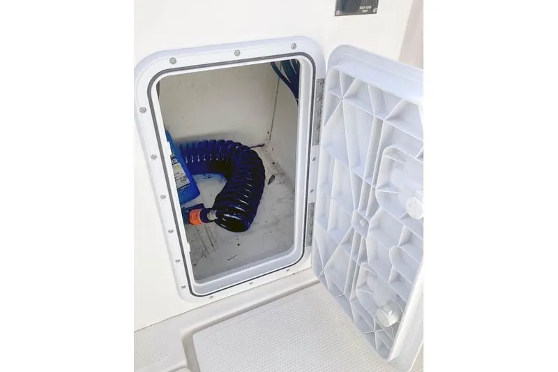 Slide: The Image of Storage compartment with coiled hose on 2021 Ranger Tugs R-25 boat. - 38