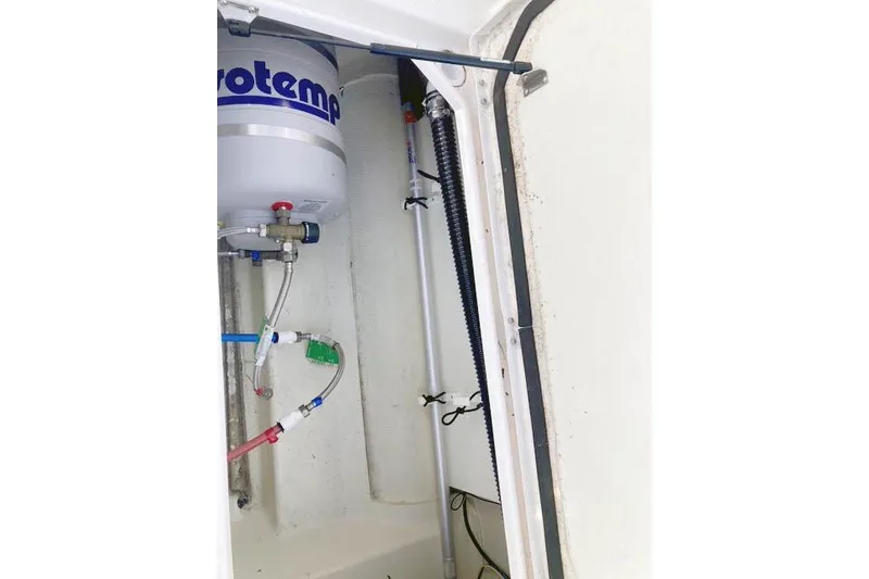 Slide: The Image of 2021 Ranger Tugs R-25 interior showing plumbing and water heater components. - 40