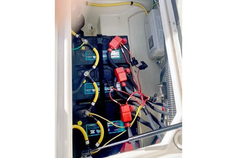 Slide: The Image of Battery compartment of 2021 Ranger Tugs R-25 boat with wiring and connections. - 43
