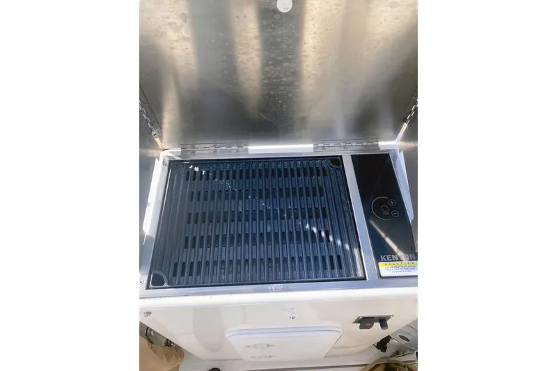 Slide: The Image of Outdoor grill on 2021 Ranger Tugs R-25 boat, featuring a sleek stainless steel design. - 44