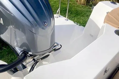 Slide: The Image of 2021 Ranger Tugs R-25 boat with Yamaha outboard motor, docked on grass. - 46