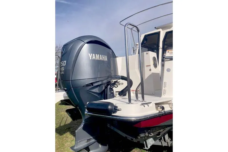 Slide: The Image of 2021 Ranger Tugs R-25 with Yamaha V6 outboard motor, docked on grass. - 47