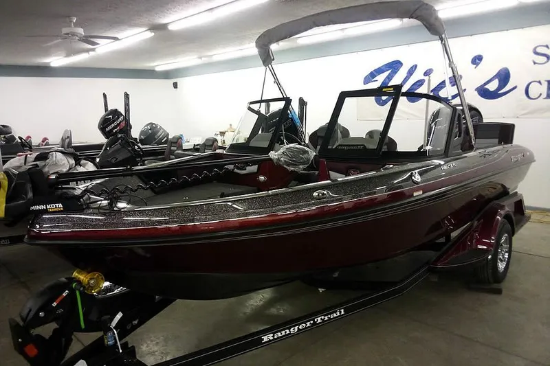 The Image of 2026 Ranger 1850MS Reata boat in showroom, featuring Minn Kota motor and sleek design. - 1