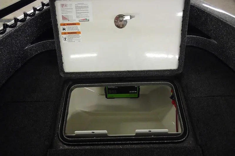 Slide: The Image of Open storage compartment in 2026 Ranger 1850MS Reata boat, featuring safety warnings. - 18