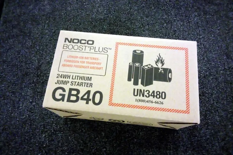 Slide: The Image of NOCO Boost Plus GB40 lithium jump starter box on a dark carpet. - 21