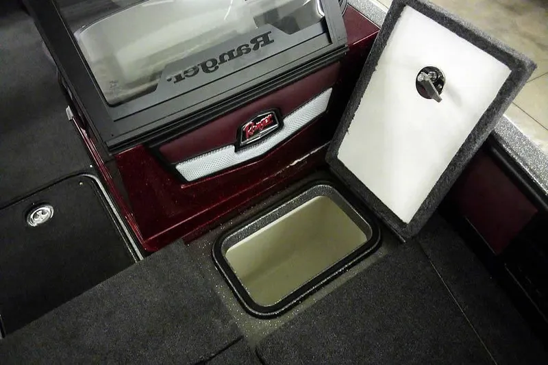 Slide: The Image of 2026 Ranger 1850MS Reata boat interior with open storage compartment and logo. - 22