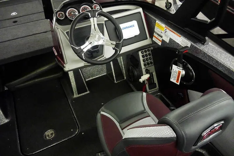 Slide: The Image of 2026 Ranger 1850MS Reata boat cockpit with steering wheel and control panel. - 31