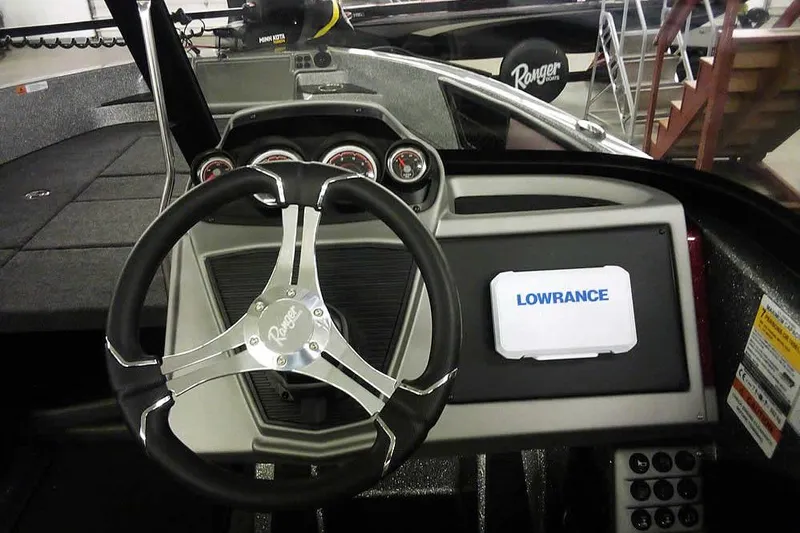 Slide: The Image of 2026 Ranger 1850MS Reata boat dashboard with steering wheel and Lowrance display. - 33