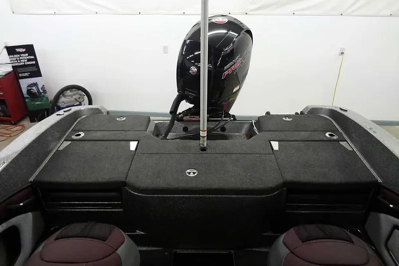 Slide: The Image of 2026 Ranger 1850MS Reata boat interior with Mercury engine, showcasing storage compartments. - 36