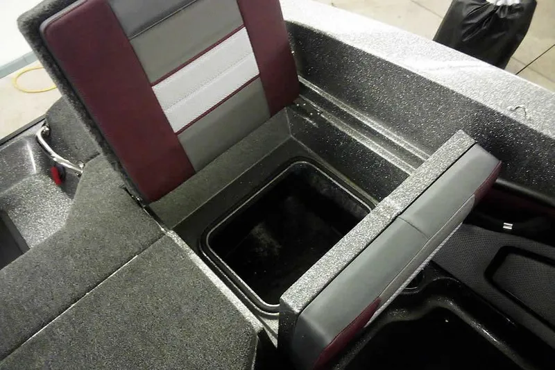 Slide: The Image of 2026 Ranger 1850MS Reata boat interior with storage compartment and cushioned seating. - 38