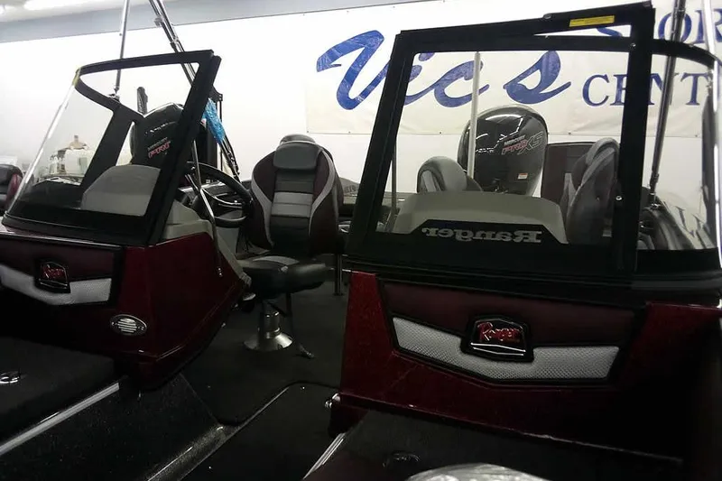 Slide: The Image of 2026 Ranger 1850MS Reata boat interior with seating and windshield in showroom. - 6
