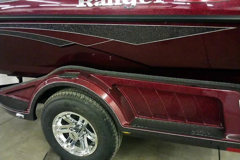 Slide: The Image of 2026 Ranger 1850MS Reata boat trailer with maroon finish and chrome wheel. - 9