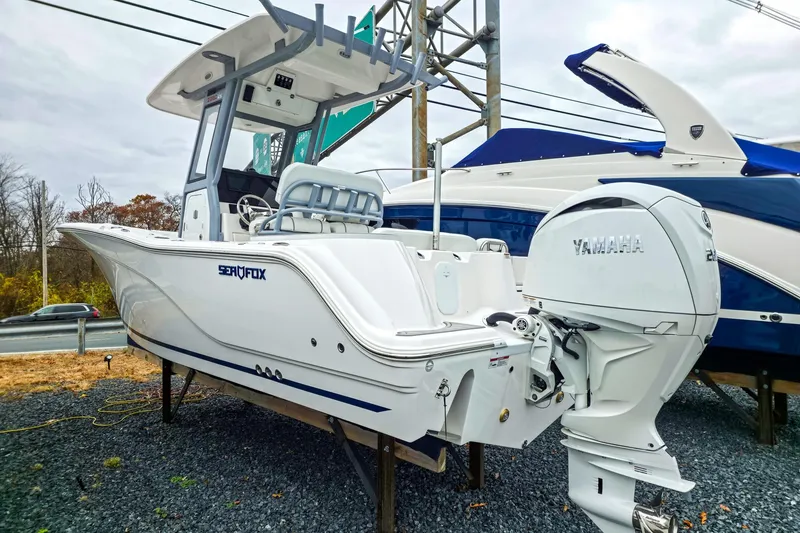 The Image of 2026 Sea Fox 228 Commander boat with Yamaha engine on display outdoors. - 0