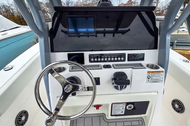 Slide: The Image of 2026 Sea Fox 228 Commander boat dashboard with steering wheel and control panel. - 10