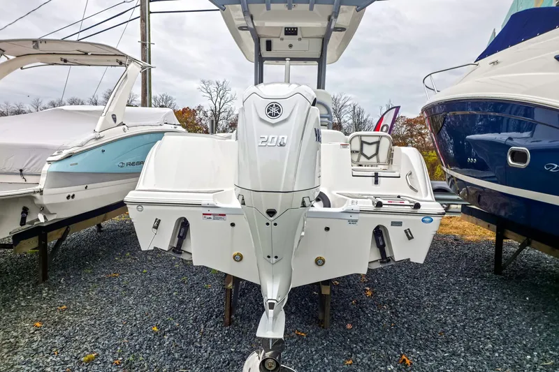 Slide: The Image of 2026 Sea Fox 228 Commander boat with Yamaha outboard motor, displayed between two other boats. - 4