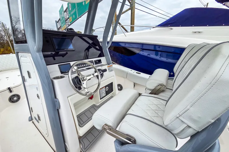 Slide: The Image of Interior view of 2026 Sea Fox 228 Commander boat, featuring steering wheel and seating. - 9