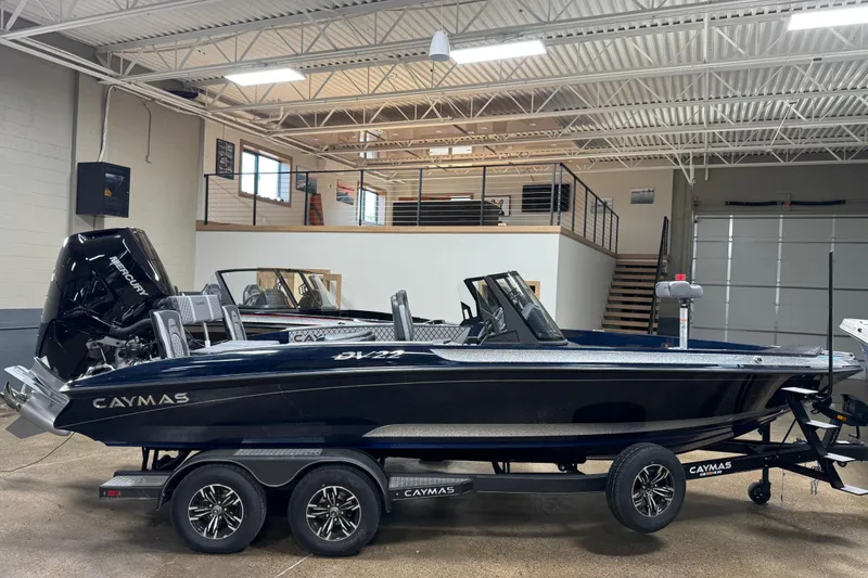 Slide: The Image of 2026 Caymas DV 22 boat in showroom, featuring sleek design and powerful Mercury engine. - 1