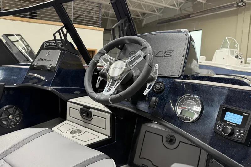 Slide: The Image of 2026 Caymas DV 22 boat interior with steering wheel, dashboard, and control panel. - 11