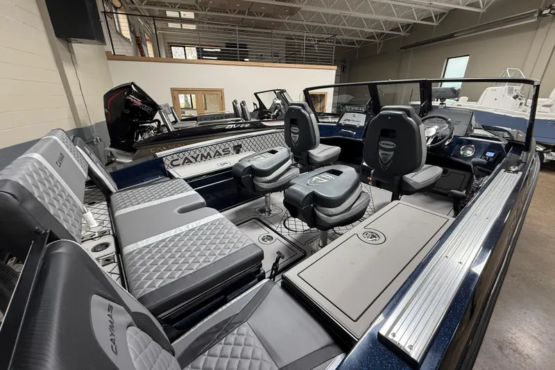 Slide: The Image of 2026 Caymas DV 22 boat interior with modern seating and sleek design in showroom. - 15