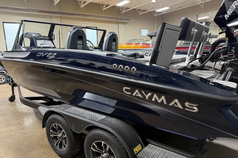 Slide: The Image of 2026 Caymas DV 22 boat on trailer in showroom, featuring sleek design and modern features. - 3