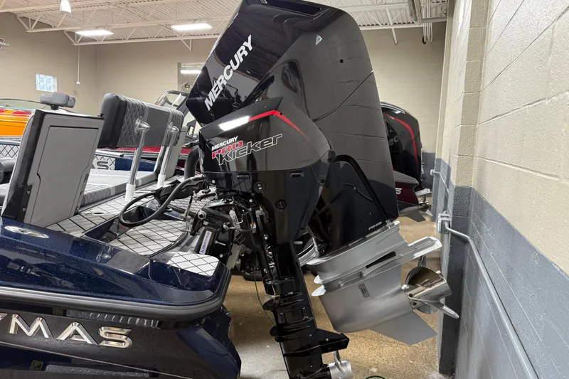 Slide: The Image of 2026 Caymas DV 22 boat with Mercury Pro Kicker outboard motor in showroom. - 4