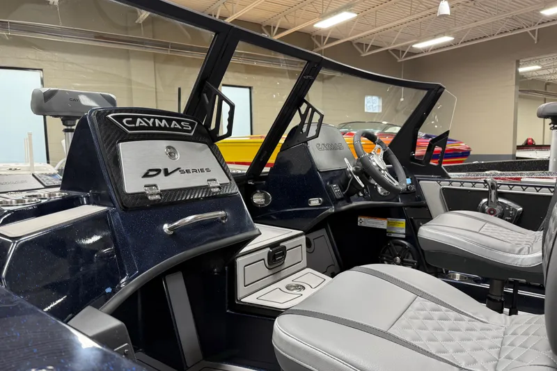 Slide: The Image of 2026 Caymas DV 22 boat interior with modern dashboard and seating. - 9