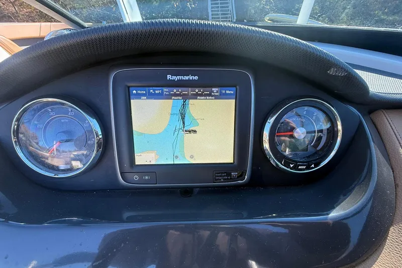 Slide: The Image of Dashboard of 2015 Sea Ray 240 Sundeck with Raymarine navigation display. - 14