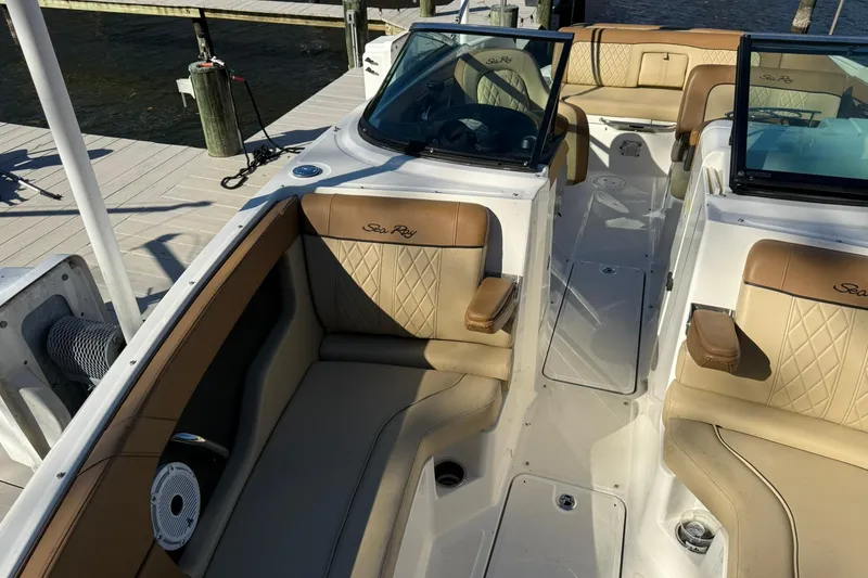 Slide: The Image of 2015 Sea Ray 240 Sundeck boat interior with tan leather seating and open deck layout. - 18