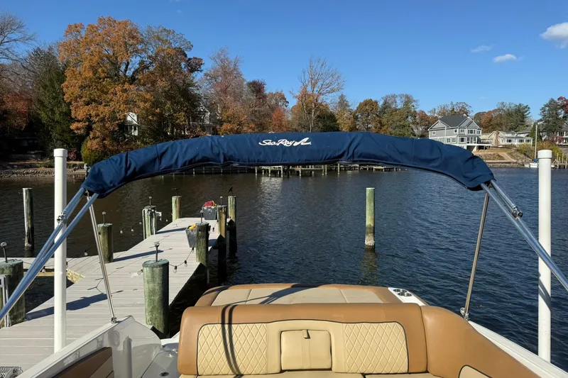Slide: The Image of 2015 Sea Ray 240 Sundeck at dock, surrounded by autumn trees and calm water. - 22