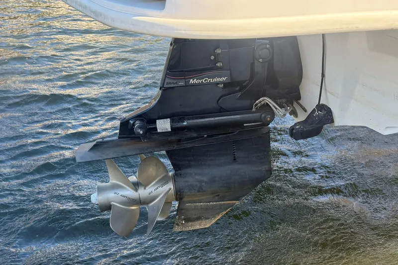 Slide: The Image of 2015 Sea Ray 240 Sundeck boat with MerCruiser Bravo Three outdrive in water. - 4