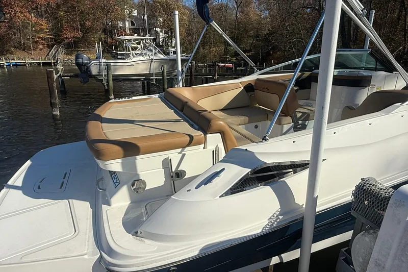 Slide: The Image of 2015 Sea Ray 240 Sundeck boat docked, featuring tan seating and sleek design. - 6