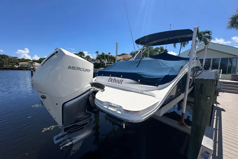 Slide: The Image of 2019 Sea Ray SDX 270 Outboard boat with Mercury engine docked by waterfront. - 1