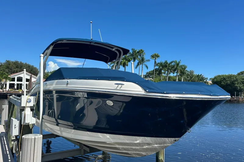 Slide: The Image of 2019 Sea Ray SDX 270 Outboard boat docked by a scenic waterfront. - 3