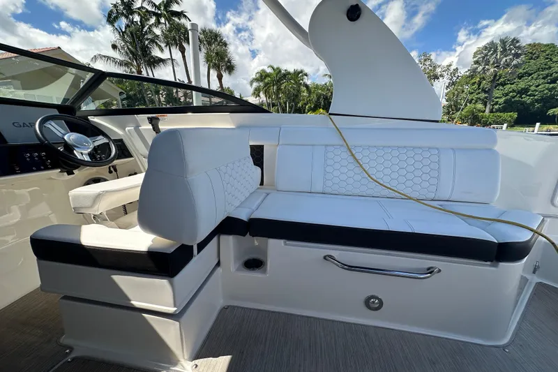 Slide: The Image of 2019 Sea Ray SDX 270 Outboard interior with white seating and steering wheel. - 5