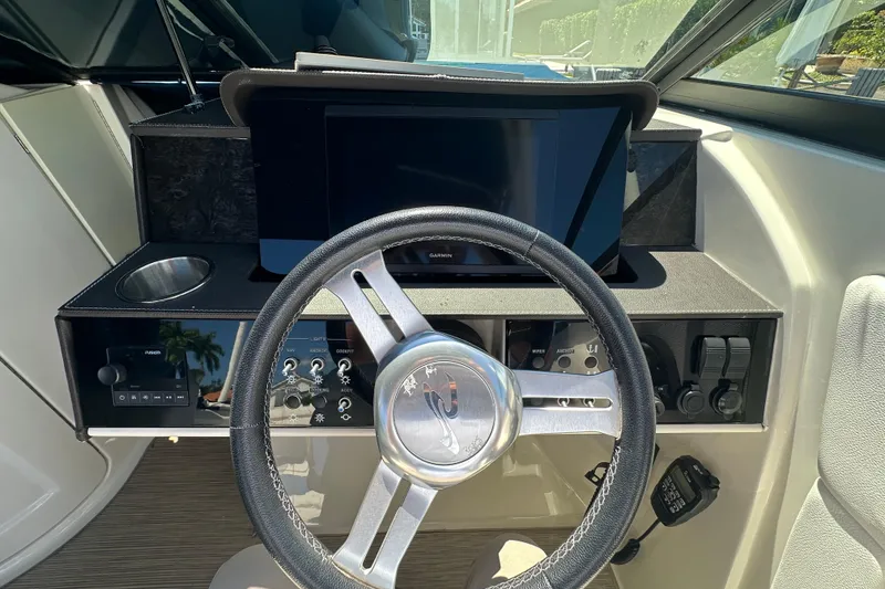 Slide: The Image of Steering console of 2019 Sea Ray SDX 270 Outboard with modern controls and display. - 7