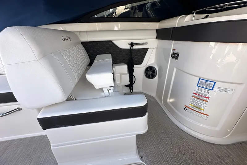 Slide: The Image of 2019 Sea Ray SDX 270 Outboard interior with white seating and modern design. - 9