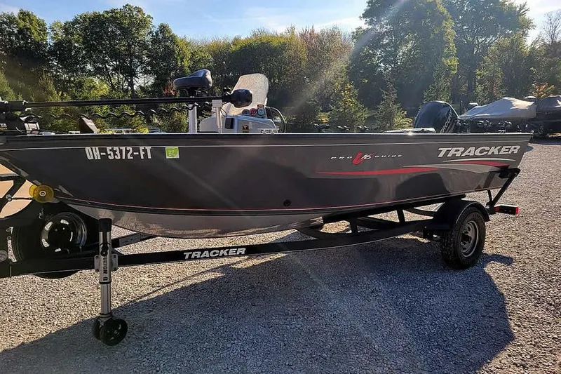 The Image of 2018 Tracker Pro Guide V-16 SC boat on trailer, parked outdoors. - 0