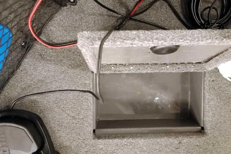 Slide: The Image of 2018 Tracker Pro Guide V-16 SC boat compartment with wiring and carpeted interior. - 12