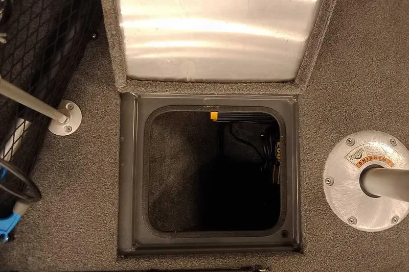 Slide: The Image of 2018 Tracker Pro Guide V-16 SC boat interior with open storage compartment. - 13