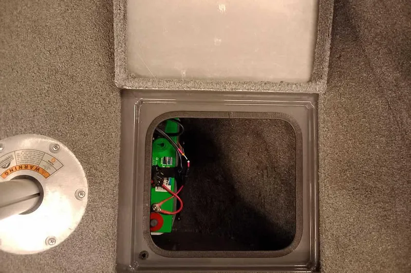 Slide: The Image of 2018 Tracker Pro Guide V-16 SC boat battery compartment with visible wiring. - 14