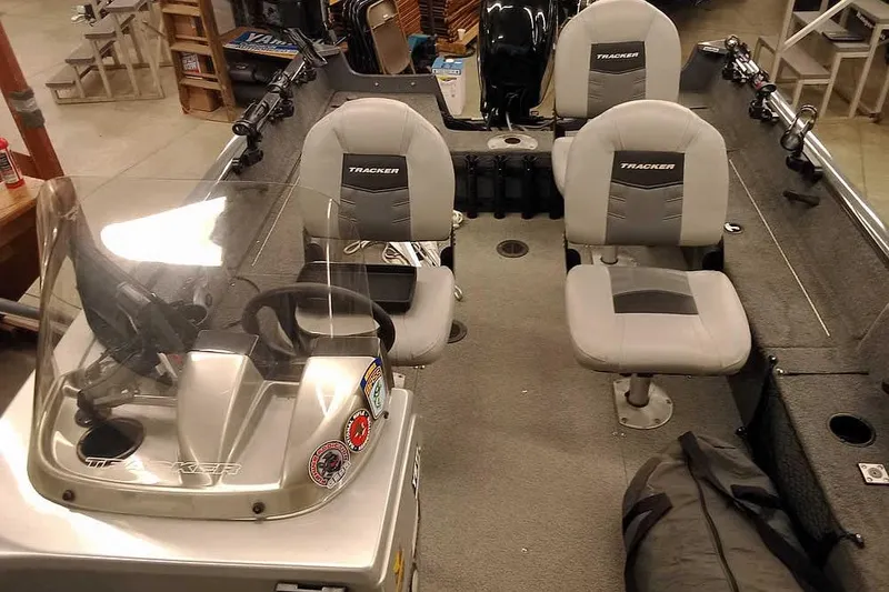 Slide: The Image of 2018 Tracker Pro Guide V-16 SC boat interior with seating and steering console. - 16