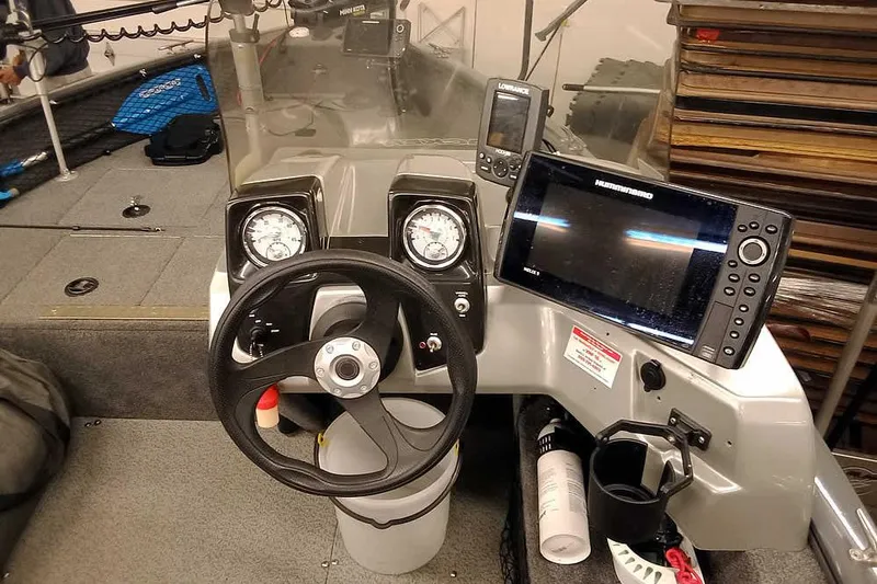 Slide: The Image of 2018 Tracker Pro Guide V-16 SC boat dashboard with steering wheel and navigation equipment. - 17