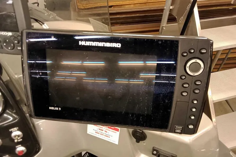 Slide: The Image of Humminbird Helix 9 fish finder on 2018 Tracker Pro Guide V-16 SC boat dashboard. - 18