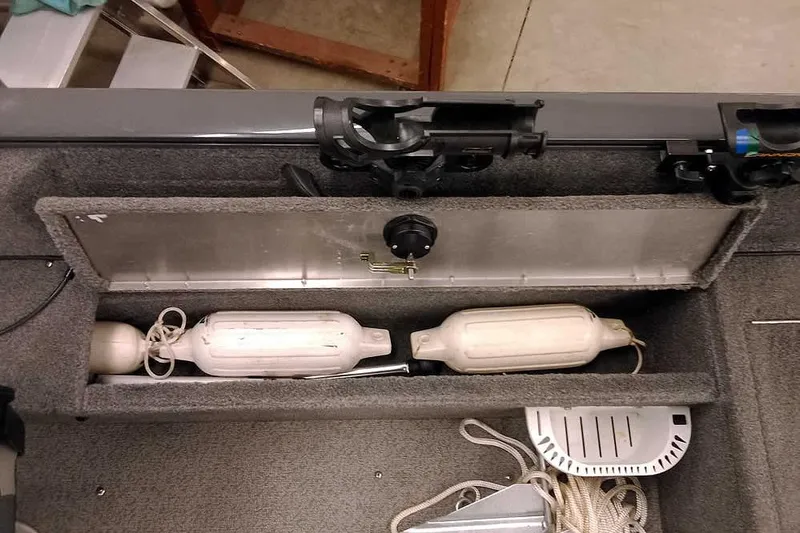 Slide: The Image of 2018 Tracker Pro Guide V-16 SC boat storage compartment with fenders and accessories. - 22