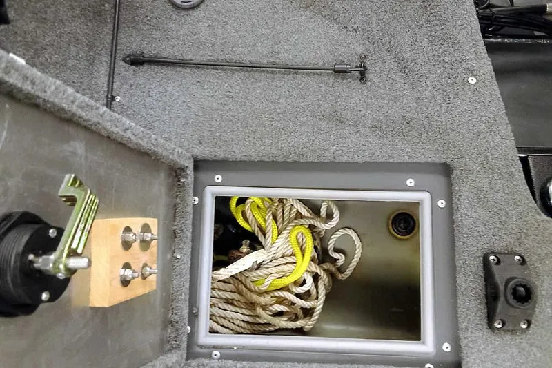 Slide: The Image of 2018 Tracker Pro Guide V-16 SC boat storage compartment with coiled rope. - 23