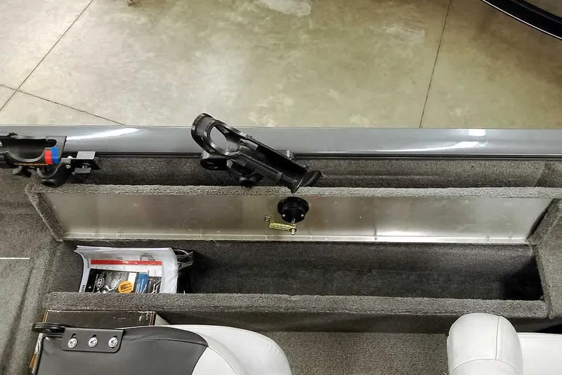 Slide: The Image of 2018 Tracker Pro Guide V-16 SC boat interior with rod holder and storage compartment. - 25