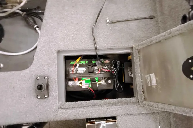 Slide: The Image of 2018 Tracker Pro Guide V-16 SC boat battery compartment with wiring and tools. - 26