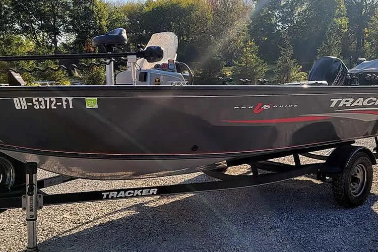 Slide: The Image of 2018 Tracker Pro Guide V-16 SC boat on trailer in outdoor setting. - 29