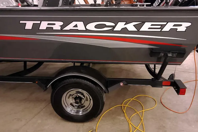 Slide: The Image of 2018 Tracker Pro Guide V-16 SC boat on trailer, side view with logo. - 3