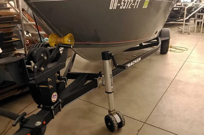 Slide: The Image of 2018 Tracker Pro Guide V-16 SC boat on trailer in garage setting. - 5
